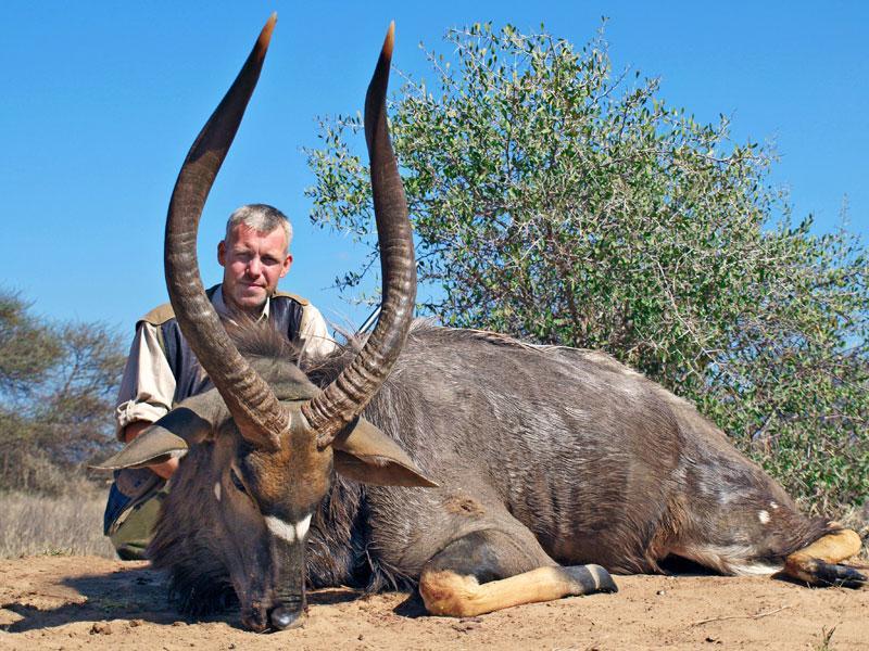 Hunter with trophy Nyala during a South African plains game safari with Mediate Expeditions.