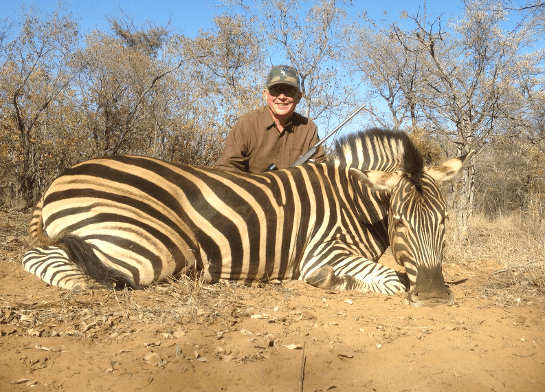 Hunter with trophy Zebra on a South African plains game hunt with Mediate Expeditions.
