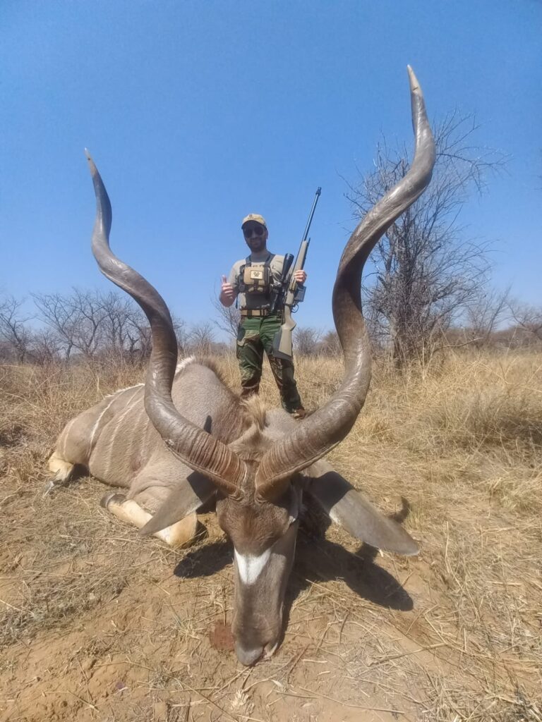Hunter posing with trophy Greater Kudu during a guided South African plains game safari with Mediate Expeditions.